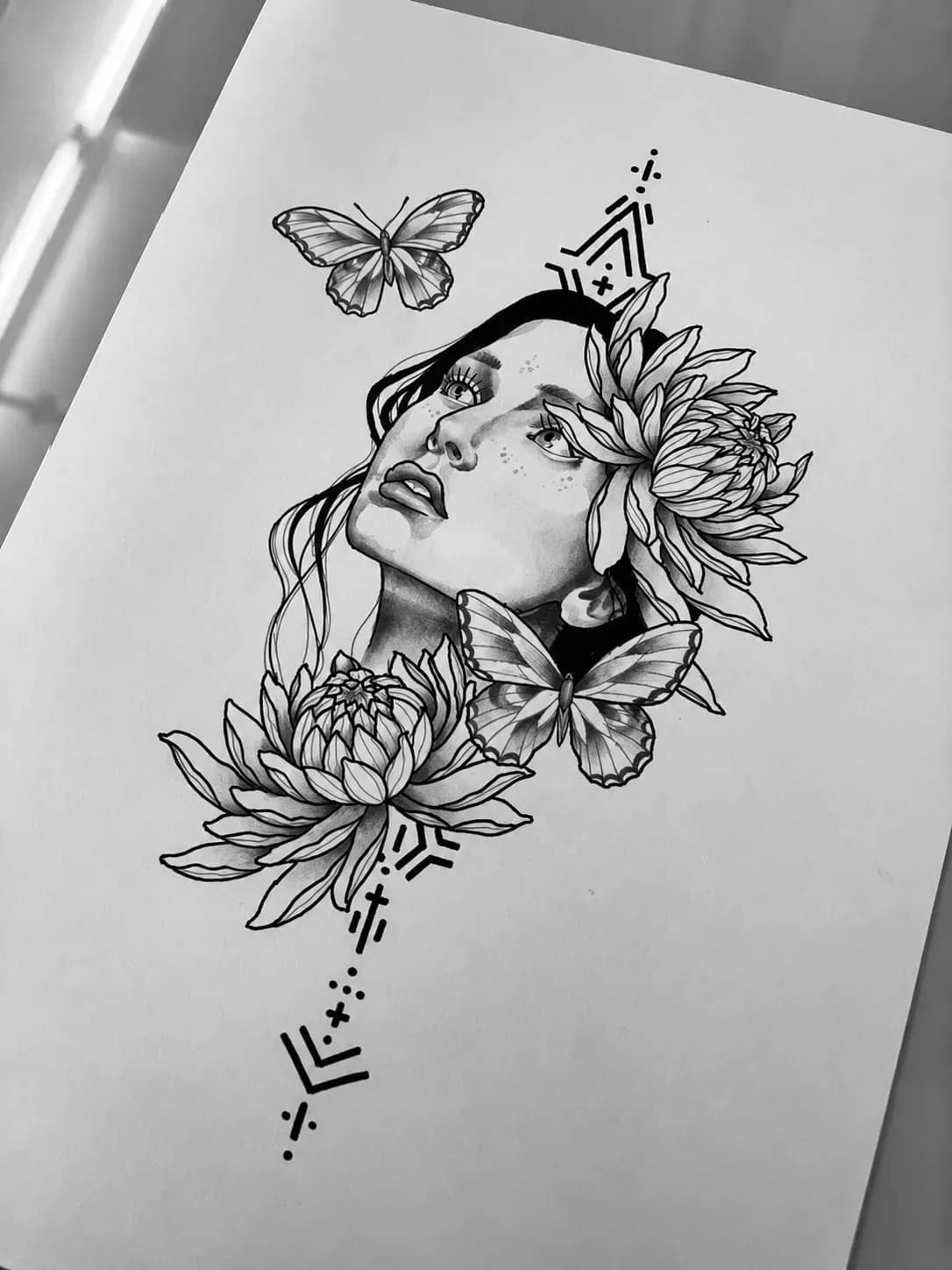 Graphite drawing of a woman with dahlias and a butterfly