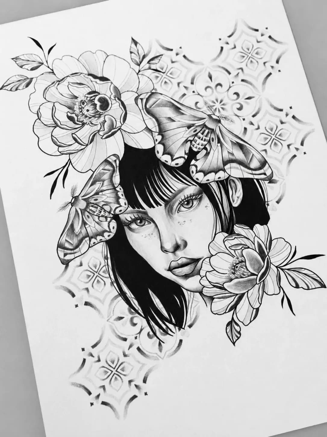 Graphite drawing of a woman with moths and a peony