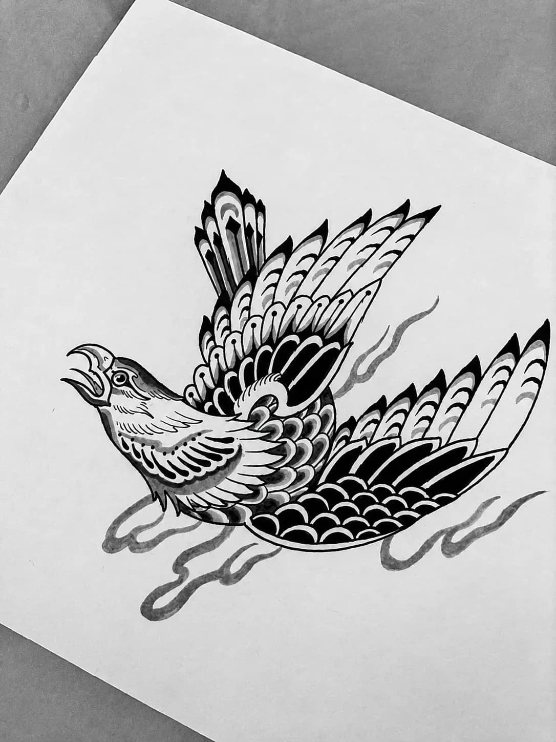 Ink-wash flash of a phoenix in flight
