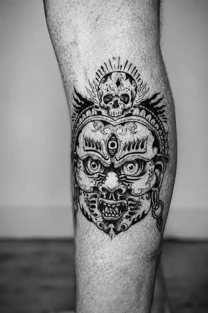 Tibetan citipati mask tattooed on a leg