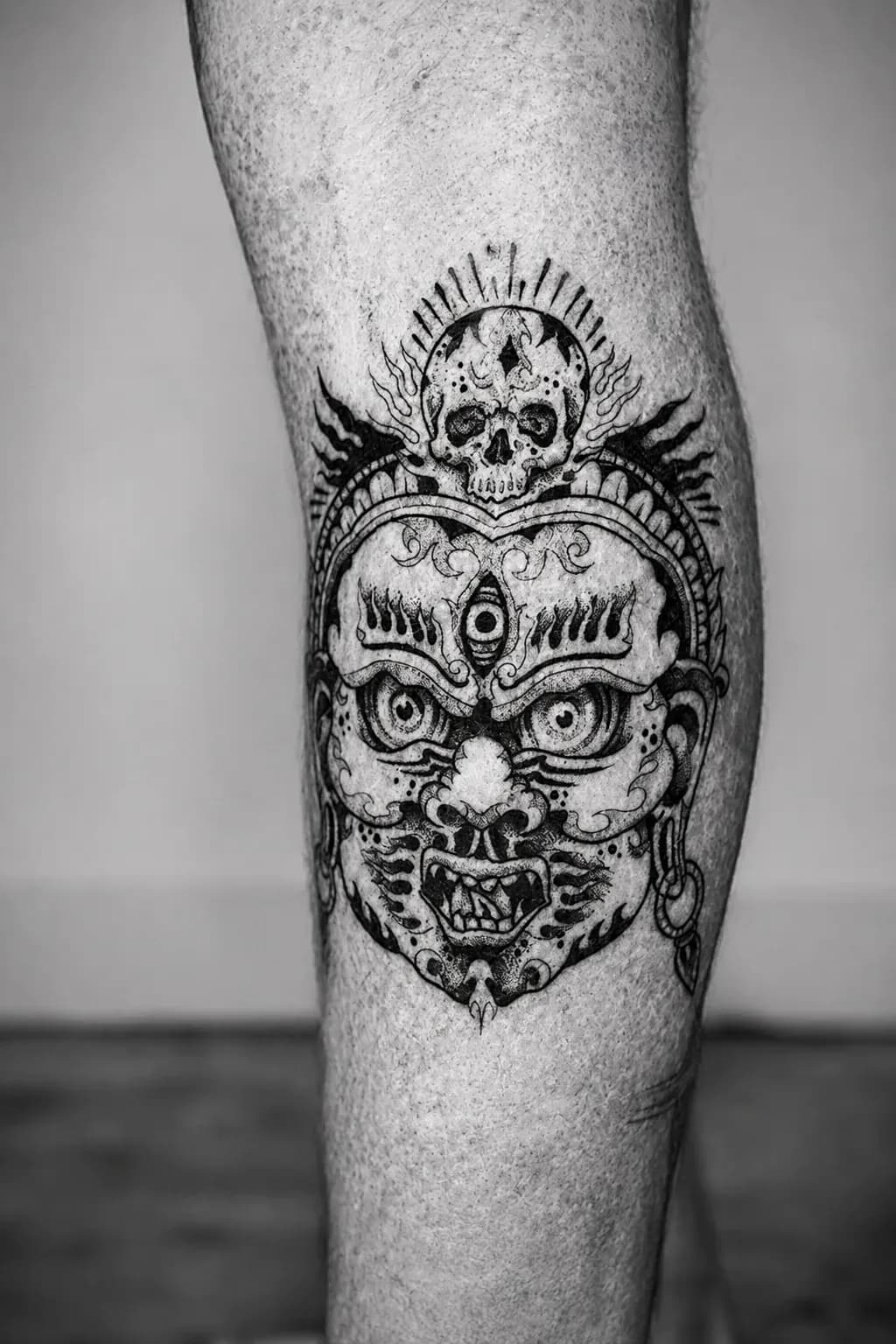 Tibetan citipati mask tattooed on a leg