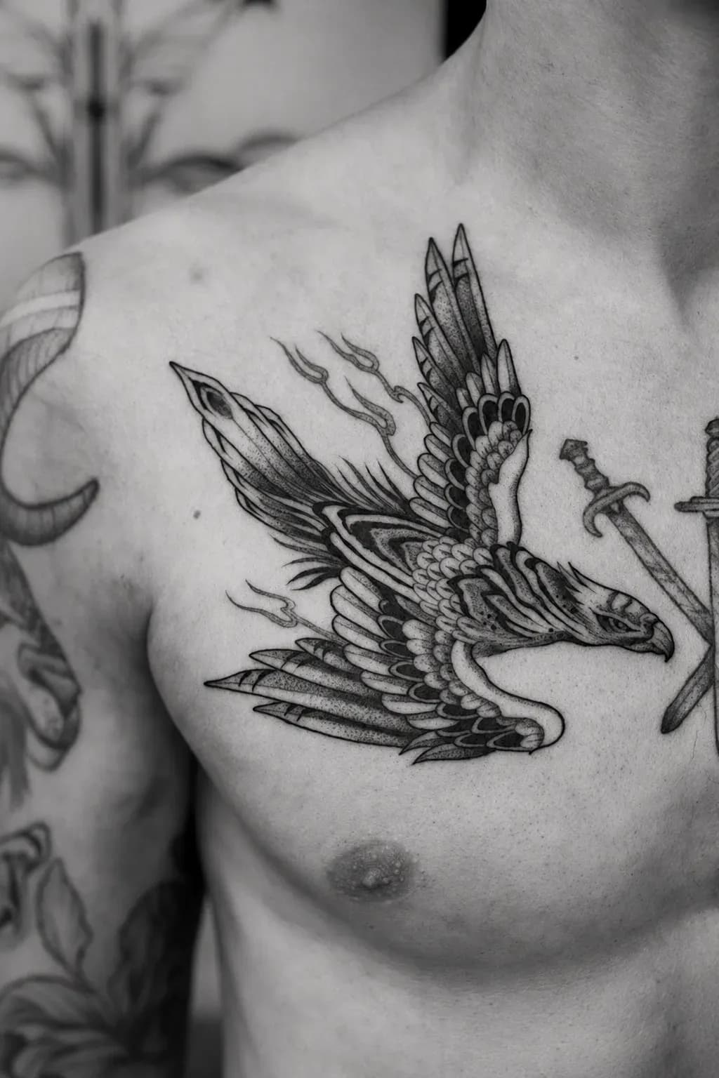 Falcon and sword tattooed on a chest