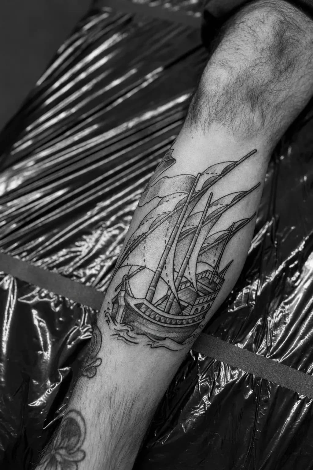 Tall sailing ship tattooed on a leg
